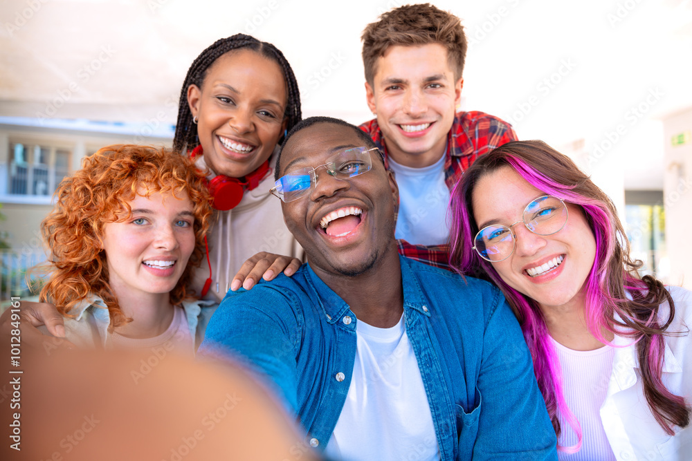 Five young multiracial friends taking a selfie portrait together outdoors Five young multiracial friends taking a selfie portrait together outdoors
