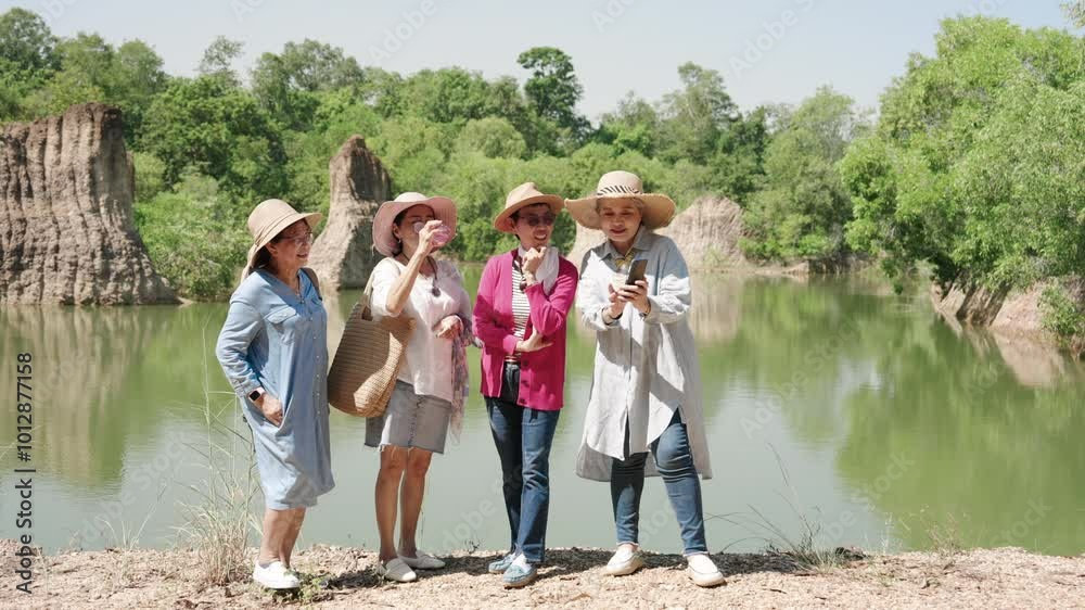 Female Elderly best friends walking in forest, take walk see nature, everyone stood rested by puddle water, after walking into forest for while, standing talking about scenery taken on phone. Female Elderly best friends walking in forest, take walk see nature, everyone stood rested by puddle water, after walking into forest for while, standing talking about scenery taken on phone.