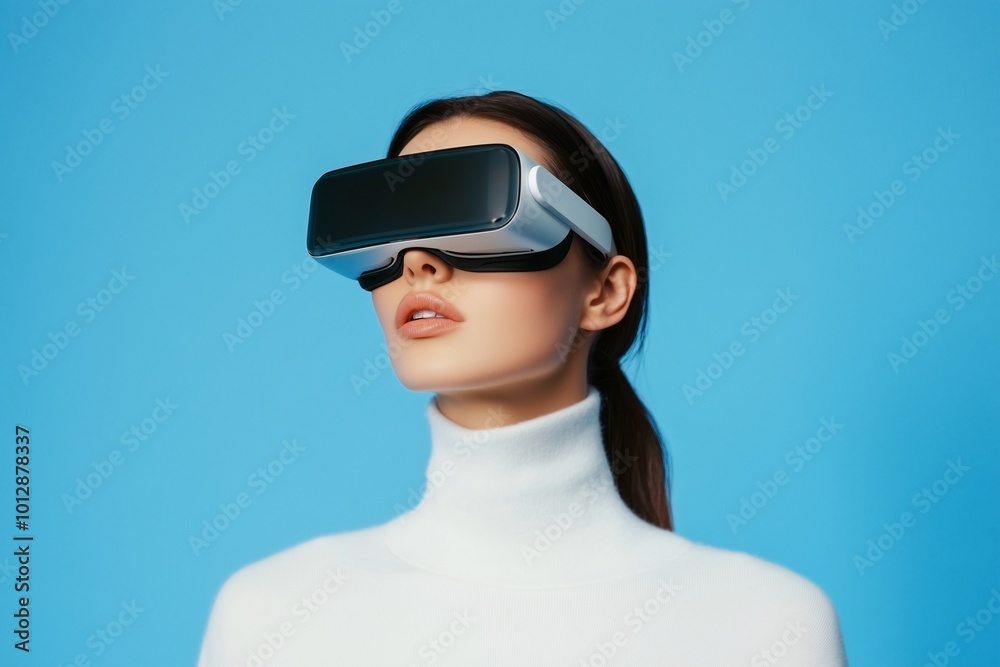 A woman wearing virtual reality goggles against a blue background. A woman wearing virtual reality goggles against a blue background.