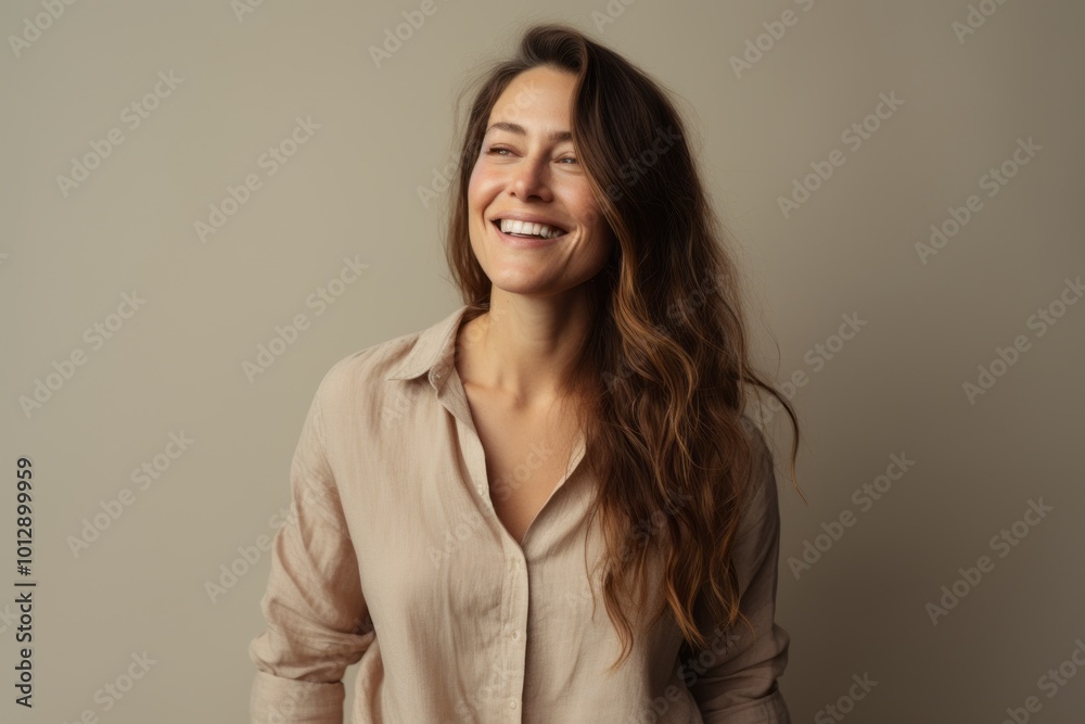 Portrait of a smiling young woman with long brown hair. Studio shot. Portrait of a smiling young woman with long brown hair. Studio shot.