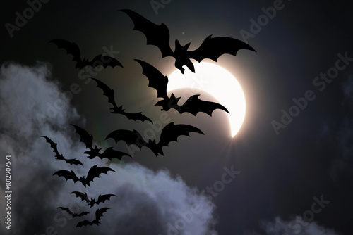 Halloween background with bats flying in the night sky and full moon. Halloween background with flying bats and full moon.