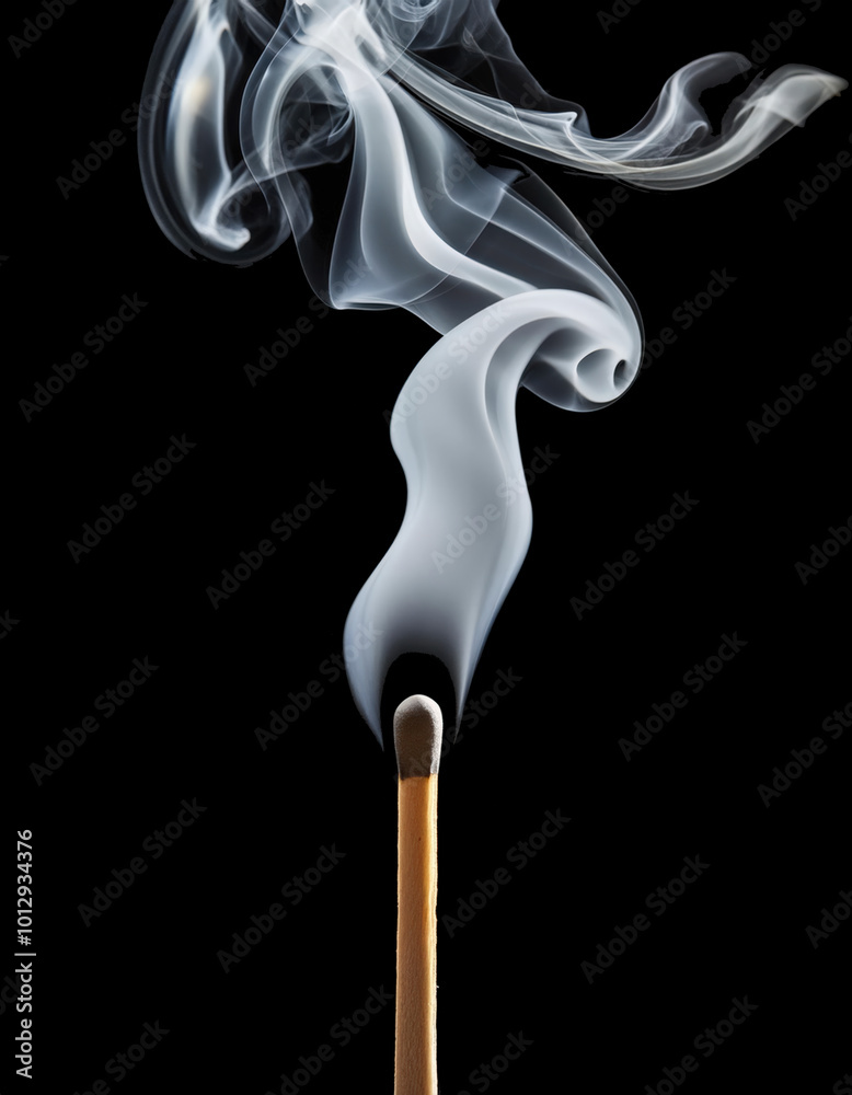 A burned matchstick with a wispy trail of smoke isolated on dark background. A burned matchstick with a wispy trail of smoke isolated on dark background.