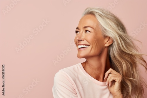 Portrait of a happy smiling middle aged woman, over pink background photo