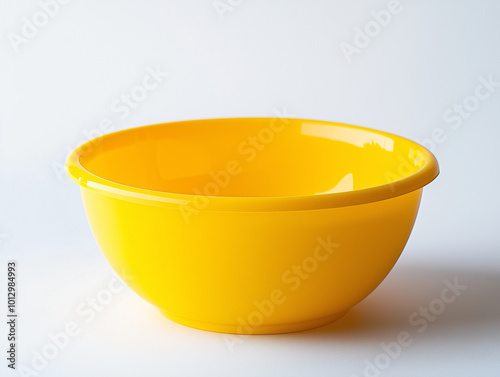 A yellow plastic bowl on white background