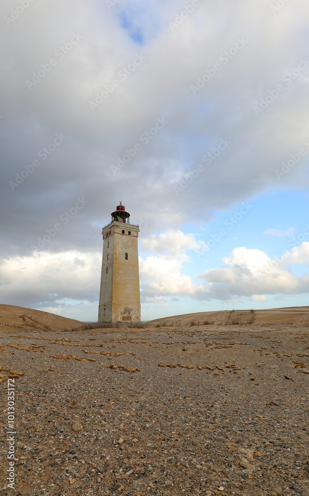 lighthouse abandoned in the remote sand and rocks of northern jutland denmark against a backdrop of vast windswept landscape lighthouse abandoned in the remote sand and rocks of northern jutland denmark against a backdrop of vast windswept landscape