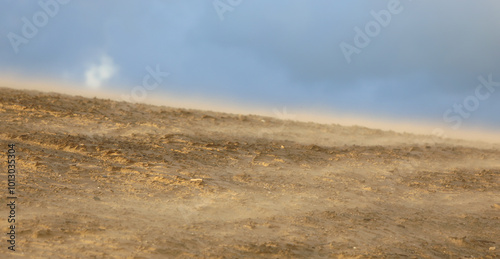 power of the wind lifts sand from a sandy dune during a storm in the desert photo