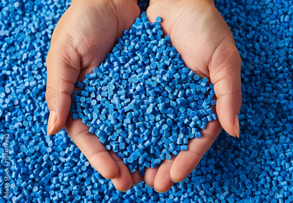 Close-Up of Blue Plastic Granules and Rubber Material with Hands. Close-Up of Blue Plastic Granules and Rubber Material with Hands.
