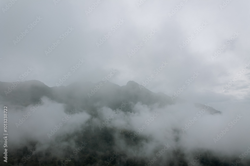 Misty mountains at dawn, shrouded in a soft veil, create a magical atmosphere of tranquility and mystery of nature Misty mountains at dawn, shrouded in a soft veil, create a magical atmosphere of tranquility and mystery of nature