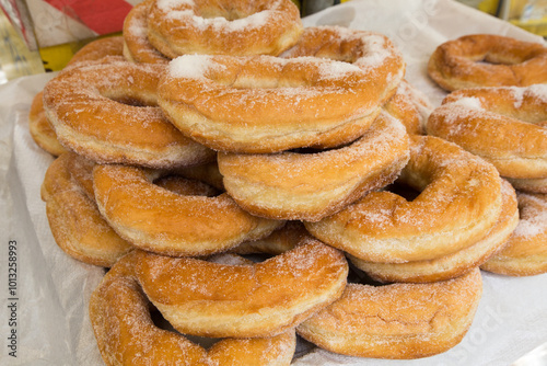 Donates covered with sugar stacked in a pile