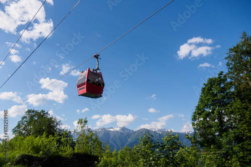 The cable car glides over picturesque mountain scenery, offering breathtaking views and an atmosphere of adventure at altitude