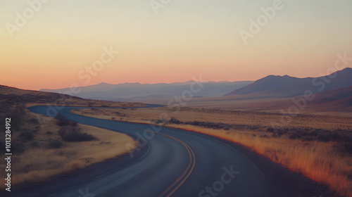 Winding road through desert landscape at sunset creates serene atmosphere