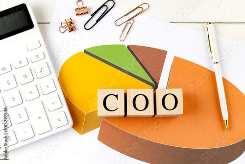 Valokuva COO chief operating officer concept with wooden blocks, calculator, and pie char