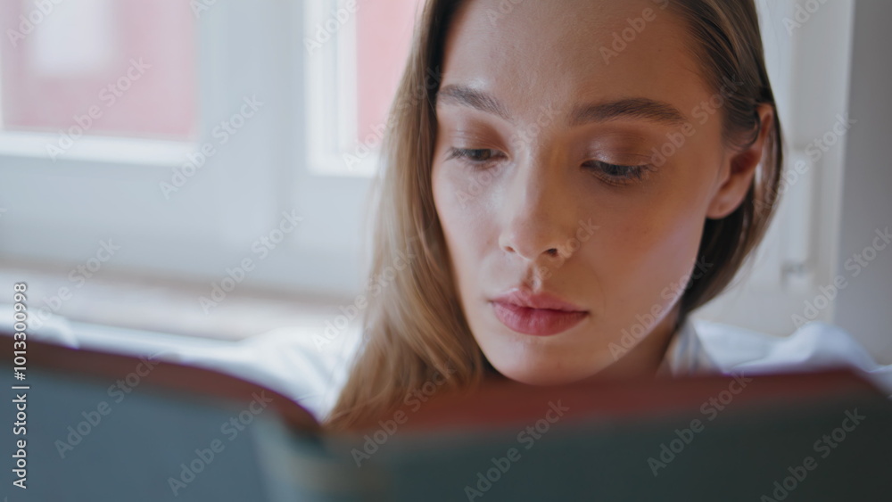 Closeup woman looking book sitting home bed. Pensive woman focused on literature Closeup woman looking book sitting home bed. Pensive woman focused on literature