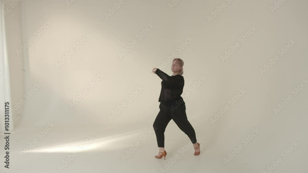 The elegant movement in a minimalist studio setting captivates viewers attention The elegant movement in a minimalist studio setting captivates viewers attention