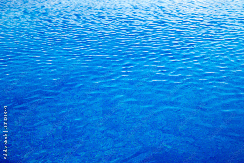 Water in swimming pool rippled water detail background.  Blue in the water in the swimming pool.