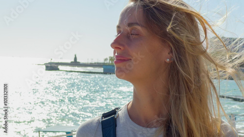 Woman Enjoying the Sea Breeze at the Waterfront, Novorossiysk, Russia photo