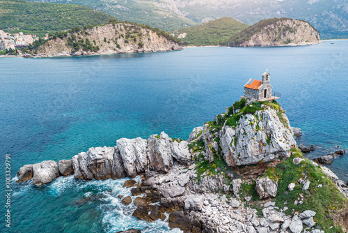 Obraz na płótnie Aerial photography of Petrovac's coastline in Montenegro, highlighting the scenic beauty of its cliffs, islets, and historic Sveta Nedjelja church, a popular destination for travelers. w salonie