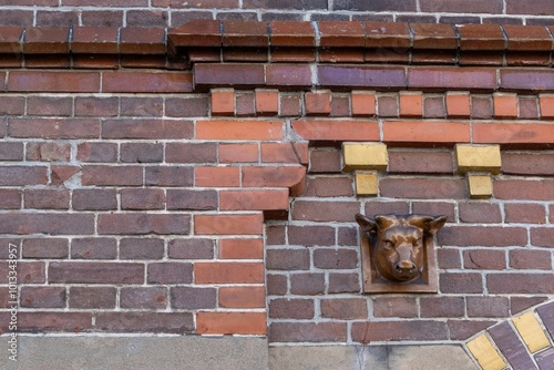 Brick facade with dentils and ox head photo