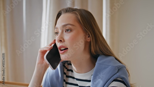 Smart woman consulting smartphone in apartment closeup. Businesswoman calling