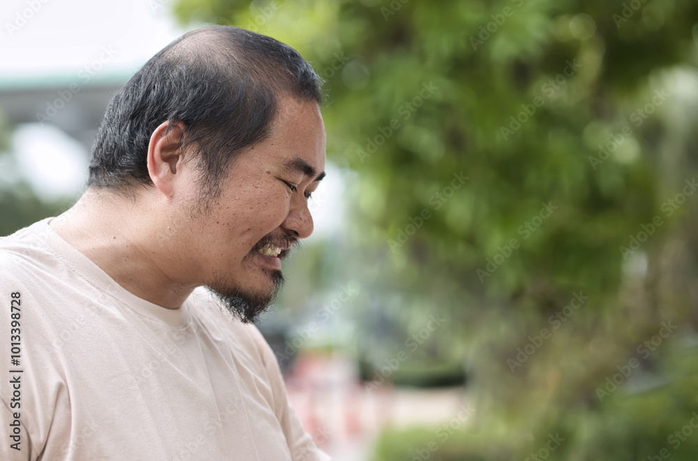 Angry middle aged asian man having upset negative expression, concept image for anger management, mindfulness awareness, mental stress, bad mental health Angry middle aged asian man having upset negative expression, concept image for anger management, mindfulness awareness, mental stress, bad mental health
