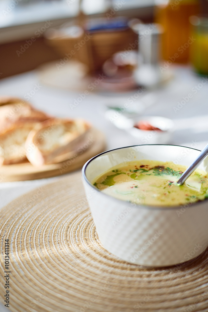 Bowl of potato soup with parsley and bacon with toasted bread croutons in white bowl. Comfort meal
