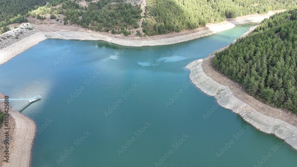 4k aerial drone view of turquoise lake covered by pine tree forest hill. 4k aerial drone view of turquoise lake covered by pine tree forest hill.