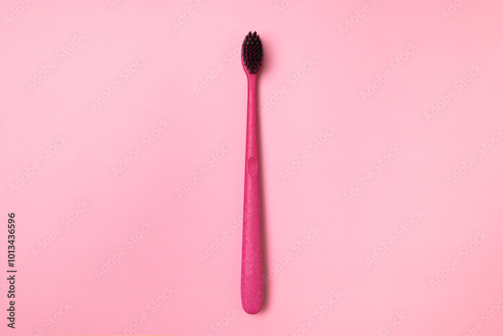 Eco-friendly bamboo toothbrushes on pink background. Natural accessories for oral hygiene, no plastic. Dental health concept top view flat lay with copy space
