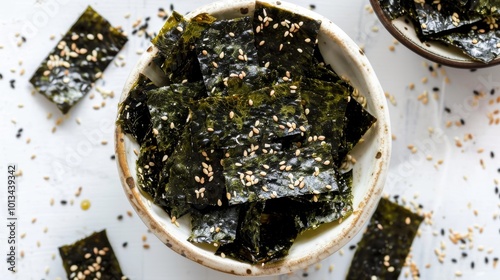 A bowl of seaweed chips with sesame seeds on top