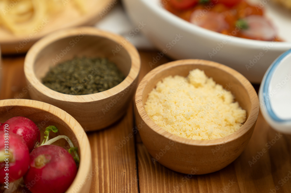 Close up in health food's Ingredients of special menu homemade cooking radish, garlic, salt, oregano, tomato and seasonings placing elements on preparing wooden table on blurred background. Postulate. Close up in health food's Ingredients of special menu homemade cooking radish, garlic, salt, oregano, tomato and seasonings placing elements on preparing wooden table on blurred background. Postulate.