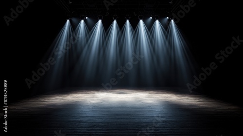 A dramatic stage with focused lights highlighting an empty performance area, perfect for theatrical presentations and events