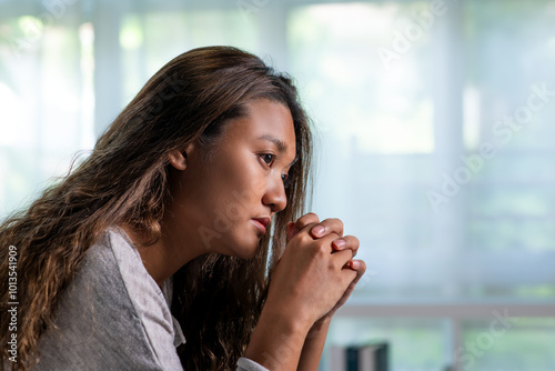 Young Asian woman sitting in a bedroom, feeling sad tired and worried suffering depression in mental health. in concept of depression anxiety and insomnia