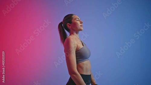 Closeup fitness woman jumping in neon sport club. Sport lady using skipping rope