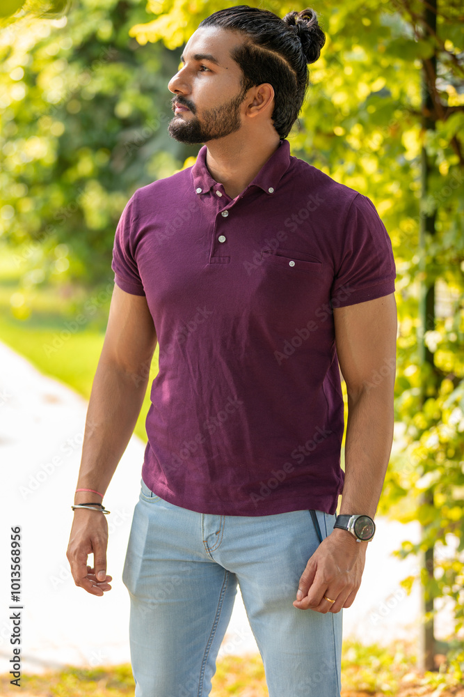 Obraz premium Close-up portrait of a confident, handsome, bearded Asian-Indian man with a ponytail. He's gazing into the distance, showing a range of facial expressions and exuding a calm demeanor.