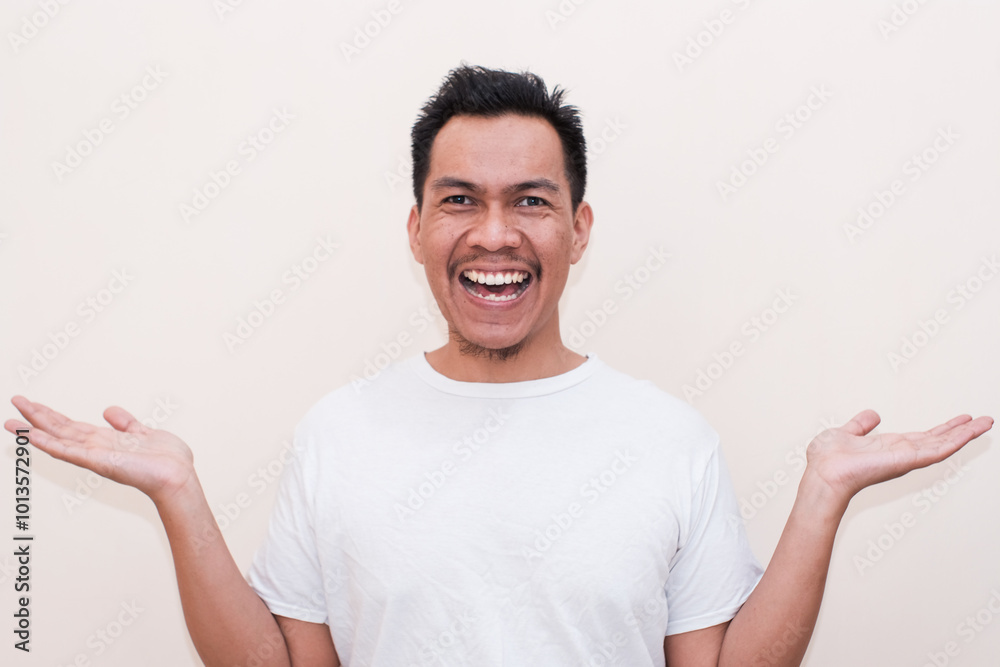 Smiling a Southeast Asian man both palms open on Isolated on white background. Creative people can put the product they want into the hands of men. Smiling a Southeast Asian man both palms open on Isolated on white background. Creative people can put the product they want into the hands of men.