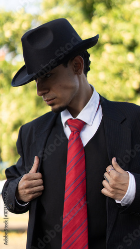 Portrait of a man in a suit and hat, elegant vintage style photo