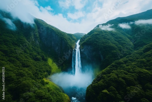 Breathtaking view of a majestic cascading waterfall surrounded by a lush verdant tropical jungle landscape nestled within a mountainous wilderness area