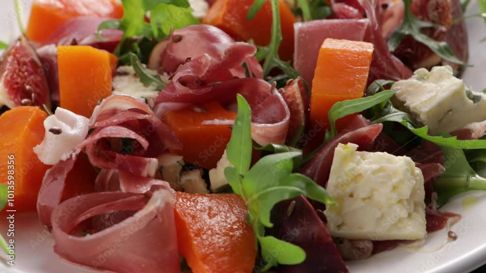 salad with pumpkin and blue cheese jamon on plate food close up salad with pumpkin and blue cheese jamon on plate food close up