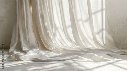 White curtains with sunlight streaming through casting shadows on the white floor.