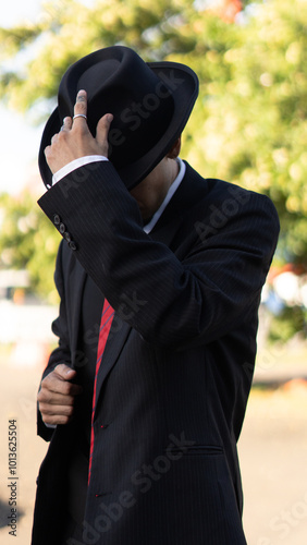 Portrait of a man in a suit and hat, elegant vintage style photo