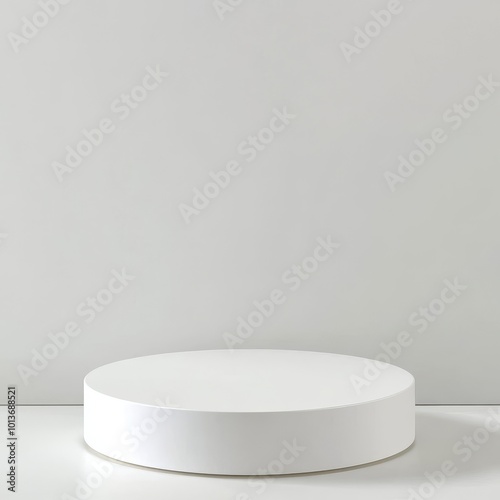 White round podium on the white wall background. 3D rendering.