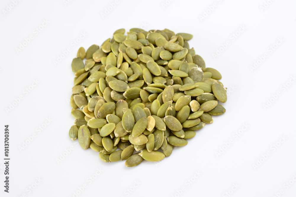 a handful of green pumpkin seeds isolated on white background a handful of green pumpkin seeds isolated on white background