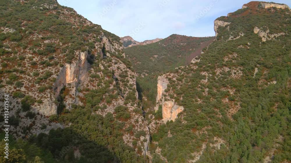 Flight over a mountain gorge. High cliffs against the blue sky, drone view Flight over a mountain gorge. High cliffs against the blue sky, drone view