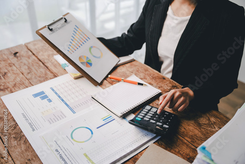 Portrait of a woman working on a tablet computer in a modern office. Make an account analysis report. real estate investment information financial and tax system concepts..