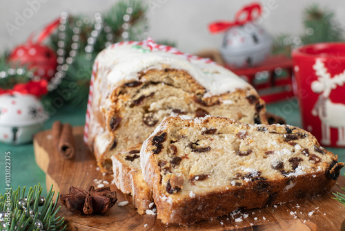 Christmas German Stollen on wooden board on gray background. Traditional treats photo