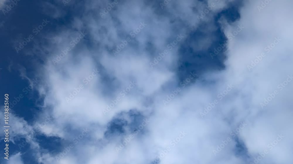 Timelapse of beautiful white puffy clouds on a sunny bright day in summer or spring with clear blue sky background