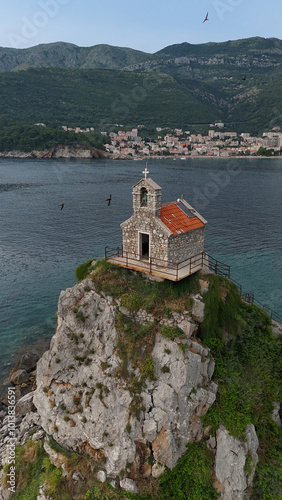 Church on a rock island rising above the sea, photo above.