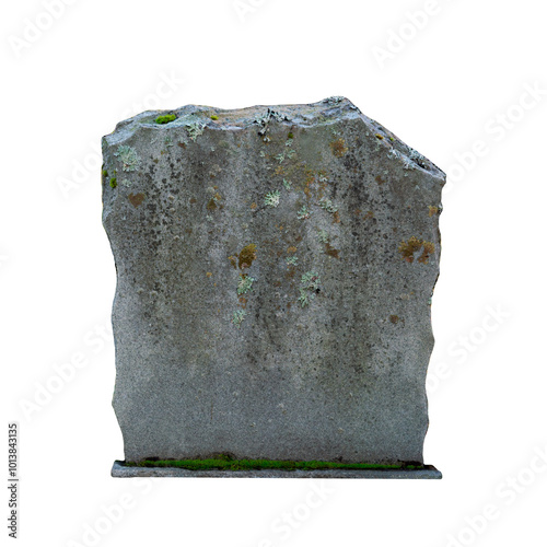 Isolated old gray jagged tombstone (no text) with moss growing on it.