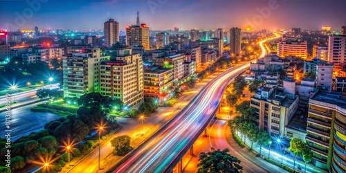 Night cityscape view of illuminated metropolitan area with light trails on the road