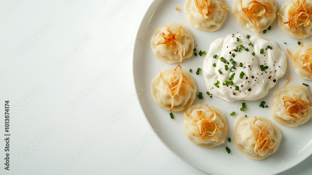 Ukrainian dumplings laid out on a white plate, some of which are flavored with fried onions and sour cream, on a white background. A simple but classic representation of Ukrainian cuisine. Ukrainian dumplings laid out on a white plate, some of which are flavored with fried onions and sour cream, on a white background. A simple but classic representation of Ukrainian cuisine.