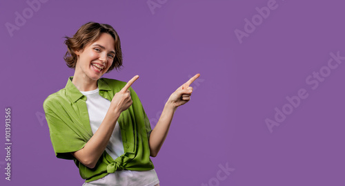 Recommending smiling woman pointing at right side, copy space or advertising. photo